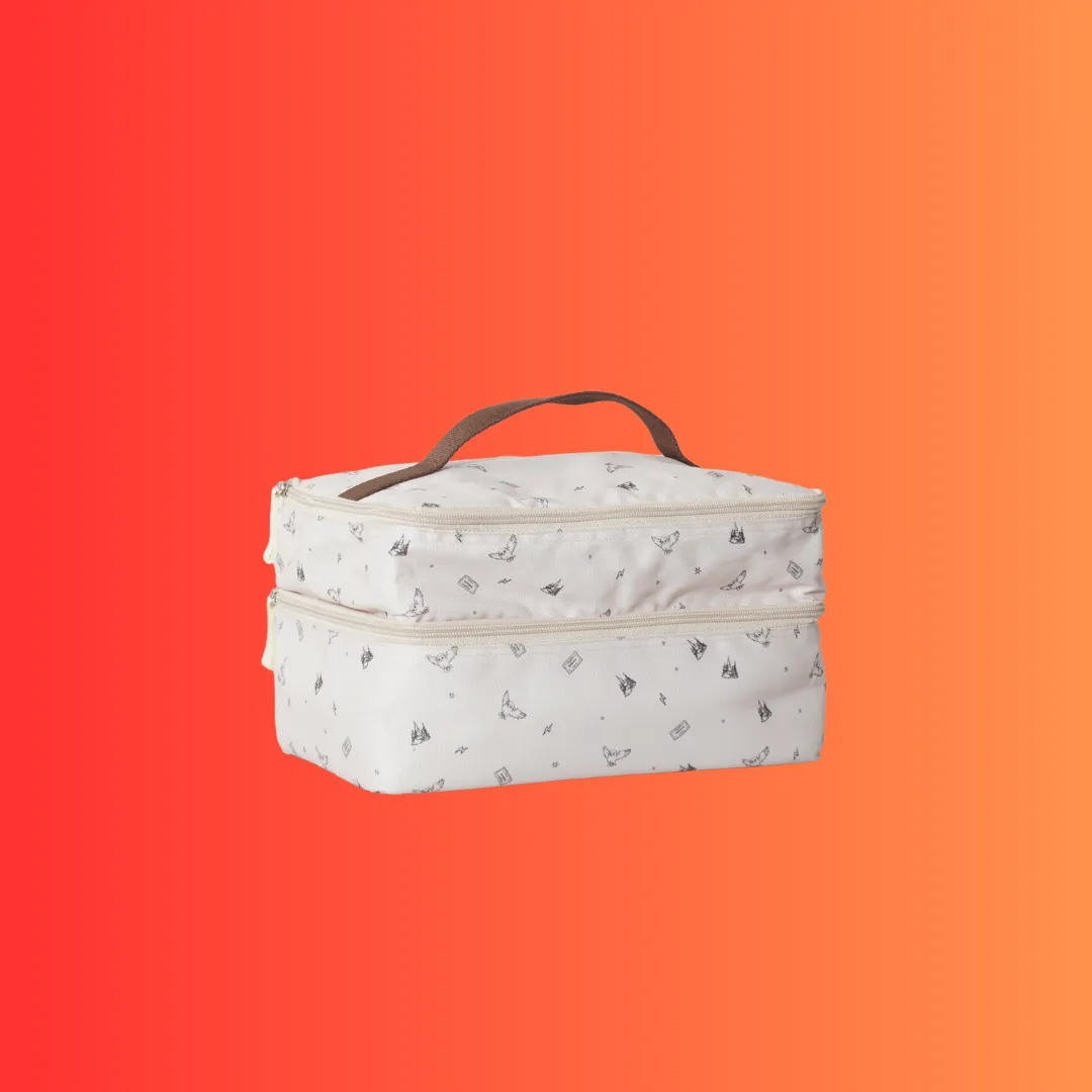 Vanity case dua tingkat dengan pegangan atas dan motif cetak halus.